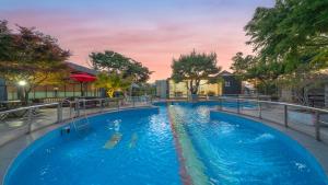 a large swimming pool with blue water at goseong theprism pension in Goseong