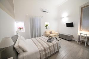 a bedroom with a bed and a chair and a table at Maris Terra in Brindisi