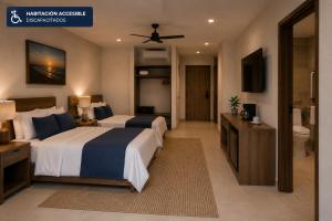 a hotel room with two beds and a bathroom at Posada Blue Sunset in Santa Cruz