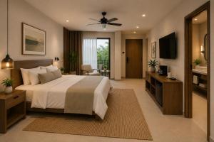 a bedroom with a large bed and a television at Posada Blue Sunset in Santa Cruz