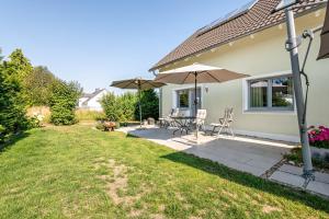 a patio with two chairs and an umbrella at Bernhards in Buch