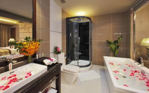 a bathroom with a tub and a toilet and a sink at Athena Hotel in Ho Chi Minh City