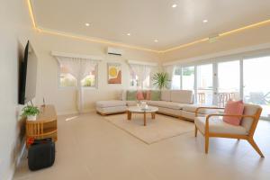 a living room with a couch and a table at Alesea Baroro, La Union, Private Modern Villa with Pool, Jacuzzi, Beachfront View in Balio +38 photos