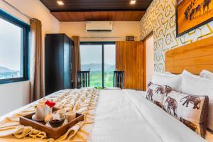 a bedroom with a large bed with a large window at Next-stay in Udaipur +60 photos