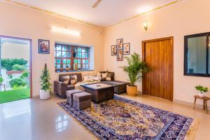 a living room with a couch and a table at Next-stay in Udaipur