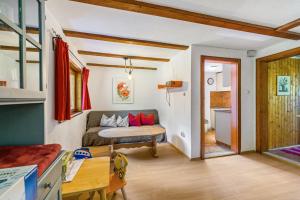 a living room with a bed and a kitchen at Haus Winterstaude in Egg