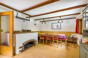 a dining room with a table and a fireplace at Haus Winterstaude in Egg +30 photos