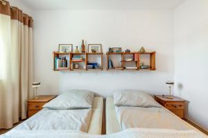 two beds in a room with shelves on the wall at Bernhards in Buch