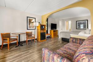 a hotel room with a bed and a table at Quality Inn Columbus near Fort Benning in Columbus +53 photos
