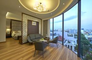 a bedroom with a bed and a room with a view at Athena Hotel in Ho Chi Minh City