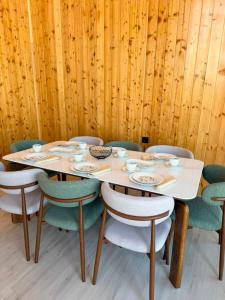 a table with chairs and plates and bowls on it at Barnhouse Allan in Koshkolʼ