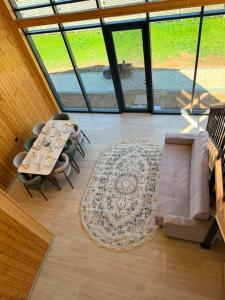 a view of a living room with a table and chairs at Barnhouse Allan in Koshkolʼ