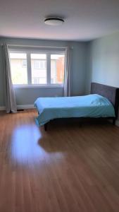 a bedroom with a bed and a large window at Fancy home in Richmond hill in Richmond Hill