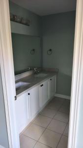 a bathroom with a sink and a mirror at Fancy home in Richmond hill in Richmond Hill
