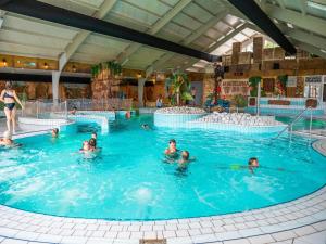 a group of people in a swimming pool at Charming Chalet Near Efteling in Kaatsheuvel