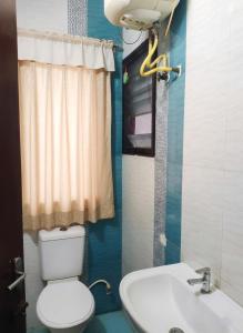 a bathroom with a white toilet and a sink at Starlighthotels OMR Thoraipakkam Chennai in Chennai +27 photos