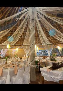 a large dining room with white tables and ceilings at Cuestas Beach Resort and Restaurant in Badian +92 photos