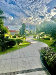 a winding road in a park under a cloudy sky at U Mall Condo in Sihanoukville