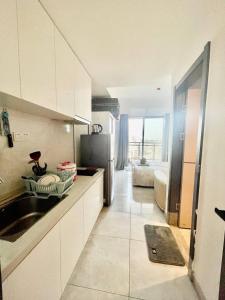 a kitchen with a sink and a refrigerator at U Mall Condo in Sihanoukville