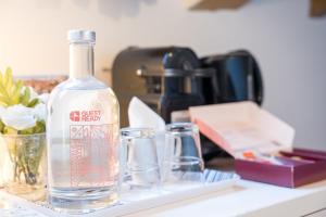 a bottle of alcohol sitting on a counter with glasses at GuestReady - Porto Home GuestHouse in Porto