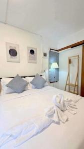 a white bed with towels on top of it at Banrao Pool Villa Khaoyai บ้านเราพูลวิลล่าเขาใหญ่ in Ban Tha Maprang +18 photos