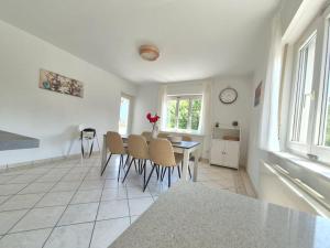 a kitchen and dining room with a table and chairs at Sunlit Lugano & Parking Free in Massagno