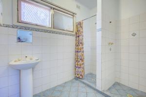 a bathroom with a sink and a shower at Ruby in Exmouth