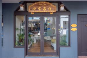 a door to a restaurant with a sign above it at iNN at Temple St by Q Loft Newly Renovated in Singapore
