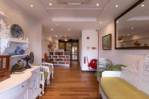 a living room with white furniture and a hallway at iNN at Temple St by Q Loft Newly Renovated in Singapore