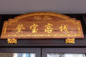 a wooden sign on top of a door at iNN at Temple St by Q Loft Newly Renovated in Singapore +63 photos