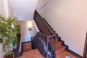 a staircase in a building with a wooden rail at iNN at Temple St by Q Loft Newly Renovated in Singapore