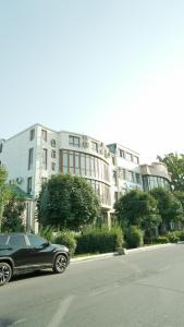 a black car parked in front of a building at KHAN Hotel in Kokand