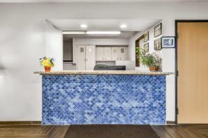 a kitchen with a blue and white counter top at Super 8 by Wyndham East Stroudsburg - Poconos in East Stroudsburg