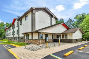 a large white building with an arch on it at Super 8 by Wyndham East Stroudsburg - Poconos in East Stroudsburg