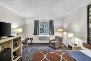 a hotel room with a bed and a flat screen tv at Super 8 by Wyndham East Stroudsburg - Poconos in East Stroudsburg