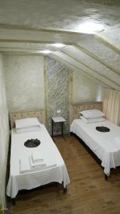 a room with two beds in a room with ceilings at KHAN Hotel in Kokand