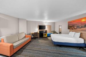 a hotel room with a bed and a couch at Days Inn by Wyndham York in York