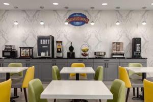 a restaurant with white tables and yellow chairs at Baymont by Wyndham La Grange KY Southeast in La Grange