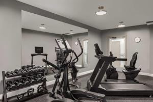 a gym with several tread machines and a mirror at Baymont by Wyndham La Grange KY Southeast in La Grange
