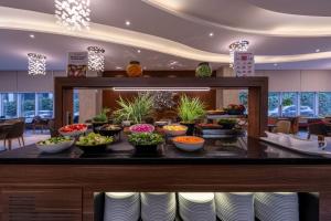 a buffet line with bowls of food in a restaurant at Ramada Encore Istanbul Bayrampasa in Istanbul