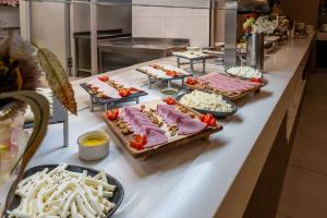 a buffet line with many different types of food at Ramada Encore Istanbul Bayrampasa in Istanbul