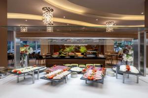 a buffet line with many different types of food on display at Ramada Encore Istanbul Bayrampasa in Istanbul