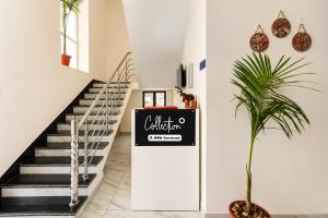 a hallway with stairs and a sign on the wall at Collection O Salasar Balaji Temple Formerly Hanuwant Palace in Sīkar