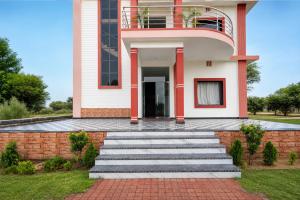 a house with a staircase in front of it at Collection O Salasar Balaji Temple Formerly Hanuwant Palace in Sīkar +28 photos