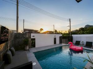 a swimming pool with a pink inflatable duck in it at The Phuview Pool Villa Aonang in Ban Chong Phli