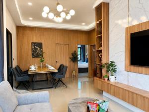 a living room with a table and a tv at The Phuview Pool Villa Aonang in Ban Chong Phli
