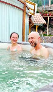 a man and a woman in a swimming pool at Arins House in Cusco