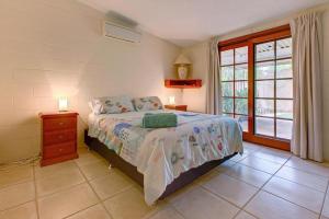 a bedroom with a bed and a dresser and a window at The Anchor in Exmouth +5 photos