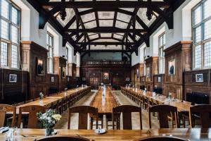 a large room with tables and chairs in it at Selwyn College, Cambridge in Cambridge