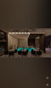 a room with tables and chairs and a swimming pool at Victor spa Apartment in Veliko Gradište